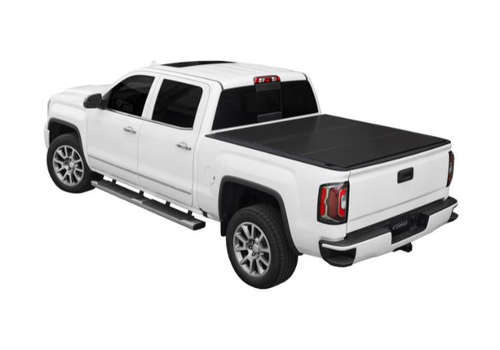 Lomax Hard Folding cover on a white GMC Sierra truck.