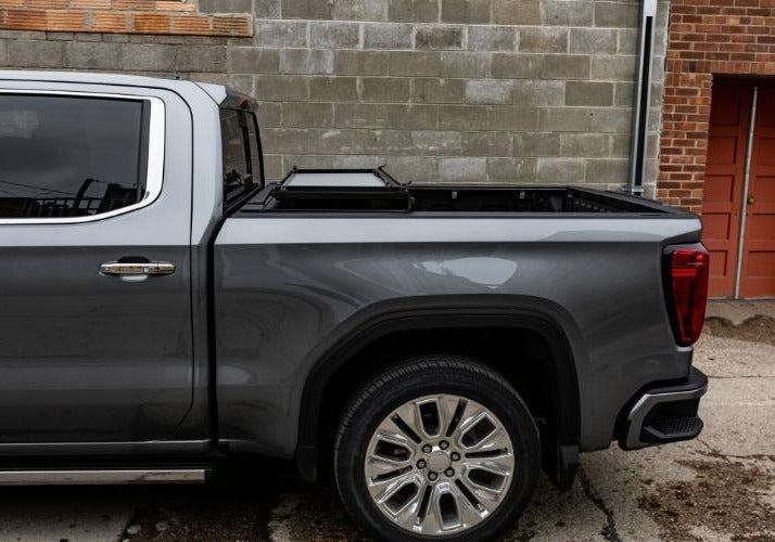 Lomax Stance Tonneau cover folded partially open on a GMC Sierra. 