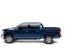 Load image into Gallery viewer, Profile view of the BAKFlip Fibermax being displayed folded open on a blue Ford F150 truck.