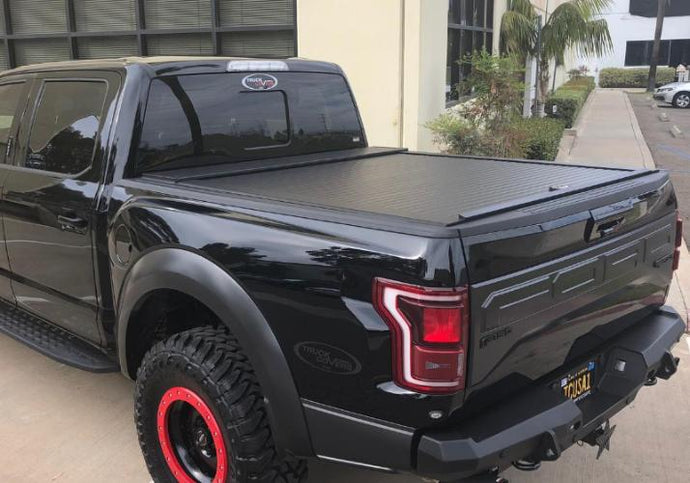 Truck Covers USA American Roll Cover displayed closed on a black Ford F150