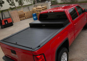 Truck Covers USA Work Cover displayed closed on a red Chevy Silverado 1500.