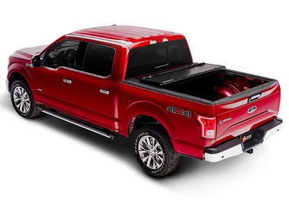 BAKFlip G2 is being displayed with two panels open on a red Ford F150 truck.