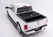 Load image into Gallery viewer, BAKFlip F1 being displayed with one panel folded open on a white Ram 1500 truck.