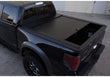 Load image into Gallery viewer, Truck Covers USA American Roll Cover displayed partially open on a black Ford F150. 