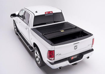 BAKFlip F1 being displayed with one panel folded open on a white Ram 1500 truck.