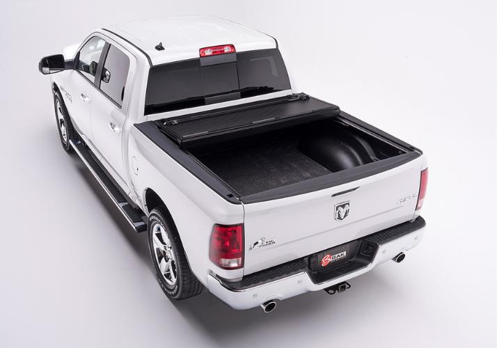 BAKFlip F1 being displayed with two panels folded open on a white Ram 1500 truck.