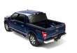 Load image into Gallery viewer, BAKFlip Fibermax being displayed folded all the way open on a blue Ford F150 truck.