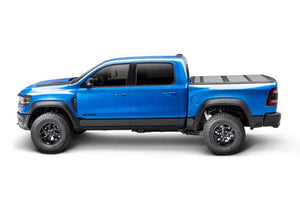 BAKFlip MX4 is being displayed closed on a blue Ram 1500 truck