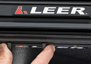 LEER Cync latching system being used with two fingers.
