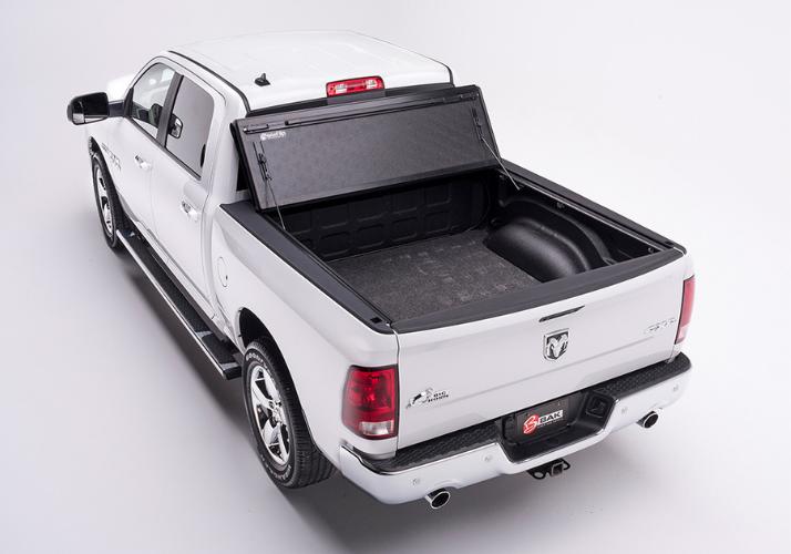 BAKFlip F1 being displayed folded all the way open on a white Ram 1500 truck.