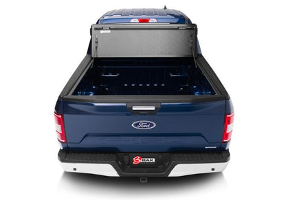 Rear view of a blue Ford F150 with the BAKFlip Fibermax folded all the way open.